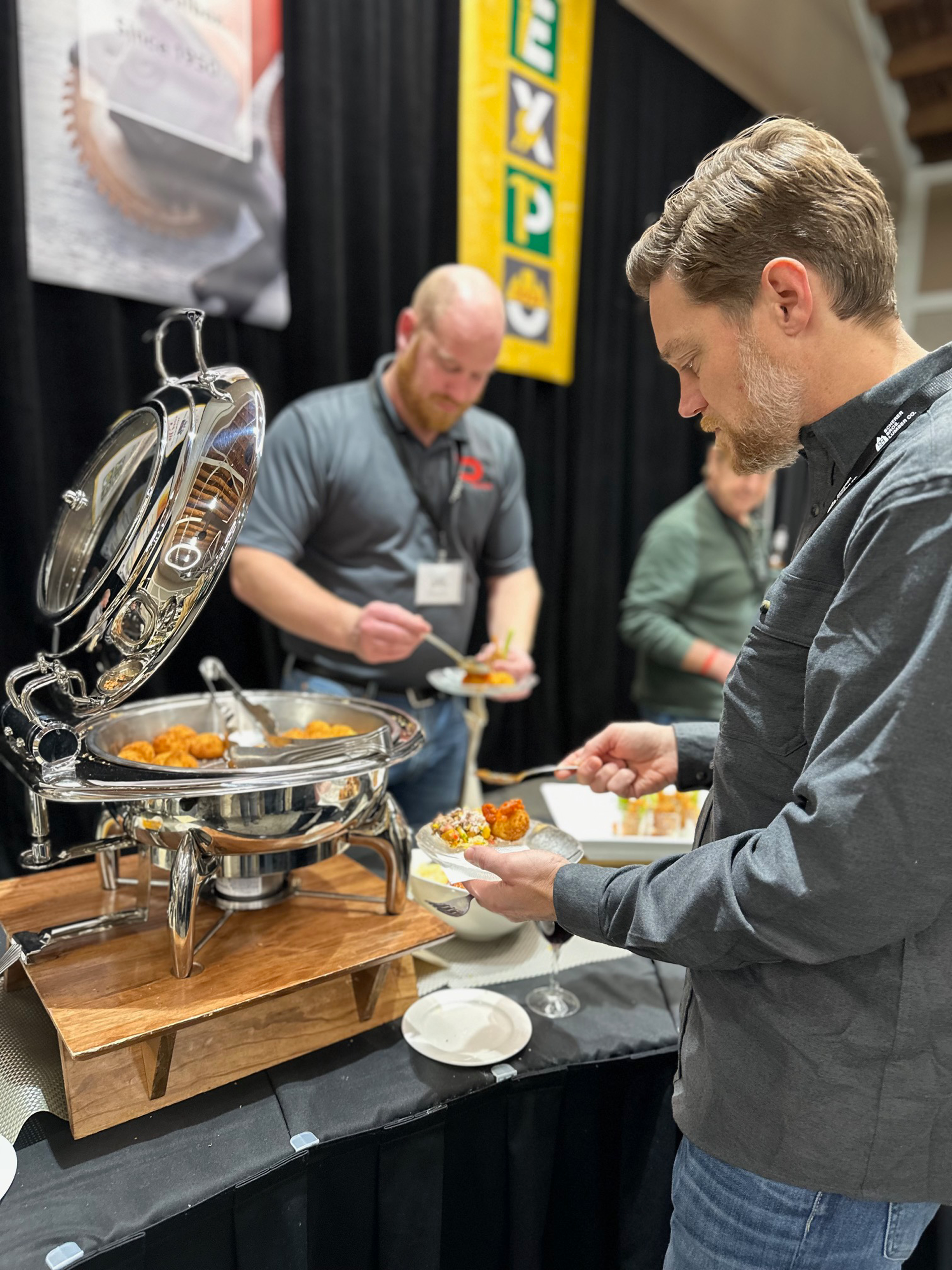 3204 2024 expo People dishing up food at an expo
